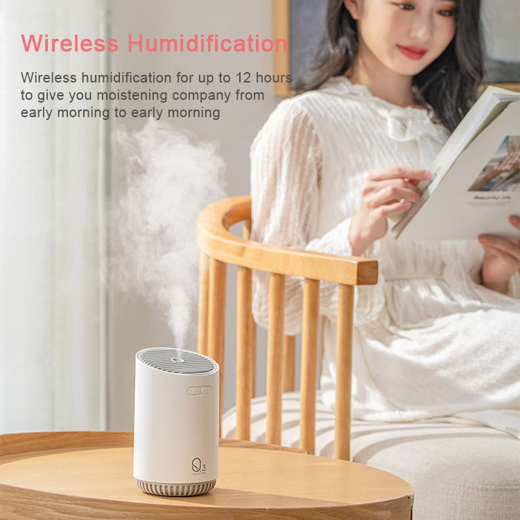 Light gray mini humidifier on a wooden stand, wireless portable humidifier with top vent.