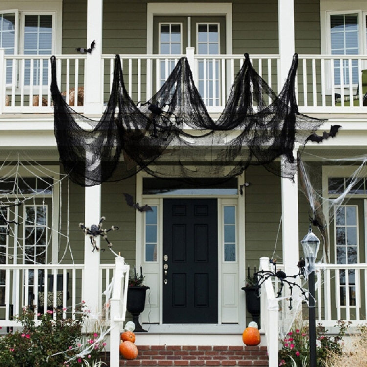Black gauze haunted-house curtain draped across the front porch near the doorway