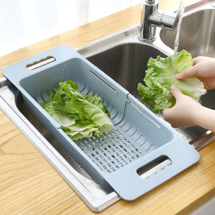 Blue plastic dish drain basket for drying leafy greens over sink