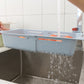 Blue adjustable dish drain basket fitted over sink with water droplets