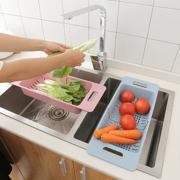 Pink and blue dish drain baskets for rinsing vegetables in kitchen sink