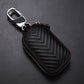 Black leather key pouch with top metal clip, red trim stitching, zigzag pattern, zipper