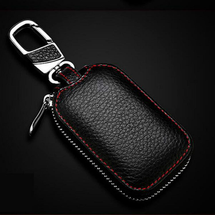 Dark leather key pouch with metal clip and ring, red piping, zipper, embossed texture
