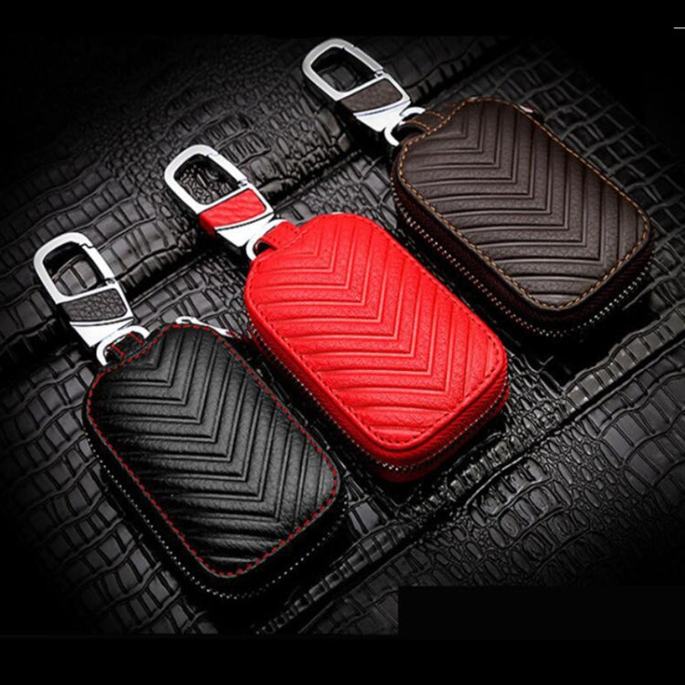 Set of three leather key pouches: black, brown, and red, with metal clips and zippers