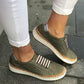 Green perforated slip-on sneakers with striped metal accent and cushioned collar