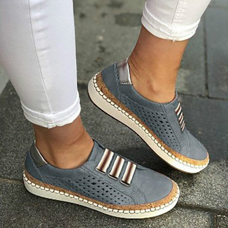 Blue perforated slip-on sneakers with striped metal accent and cushioned collar