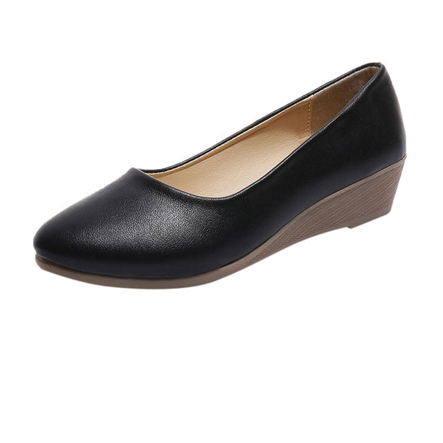 Women's black wedge shoes with rounded toe, smooth slip-on upper and low heel