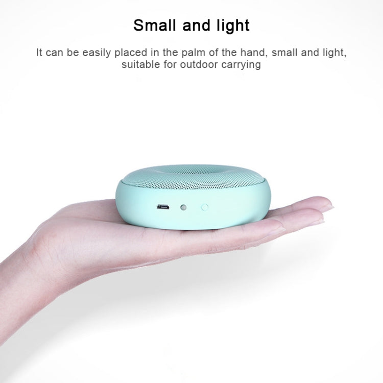 Turquoise portable air purifier with perforated top and front indicator buttons in hand