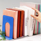 Assorted color metal bookends with U-shaped openings holding books upright
