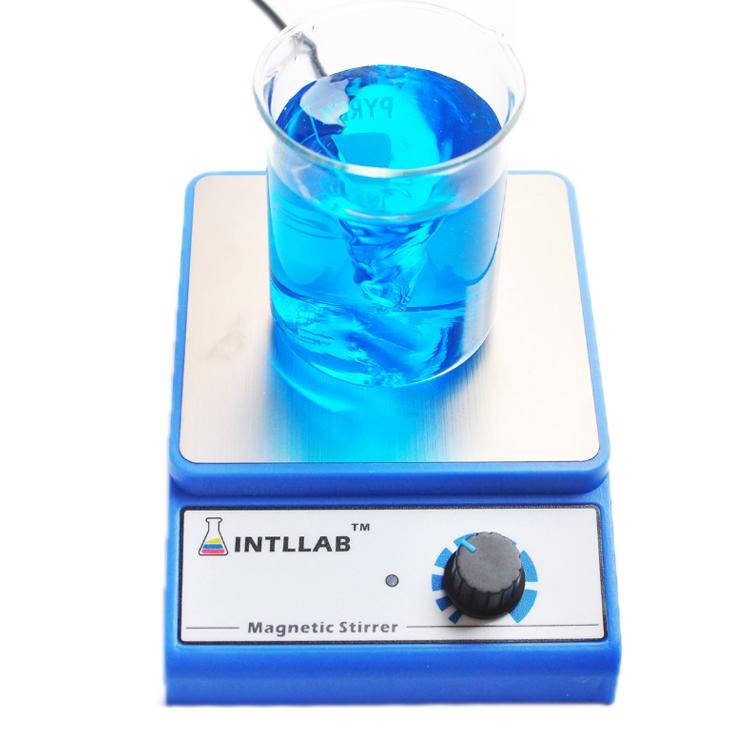 Blue magnetic stirrer base with glass beaker and blue liquid on top