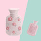 Plush hot water bottle cover in light gray with pink flower embroidery-style details