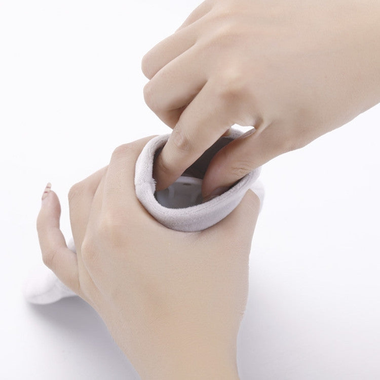 Hands holding a plush hot water bottle cover with looped opening and soft rim