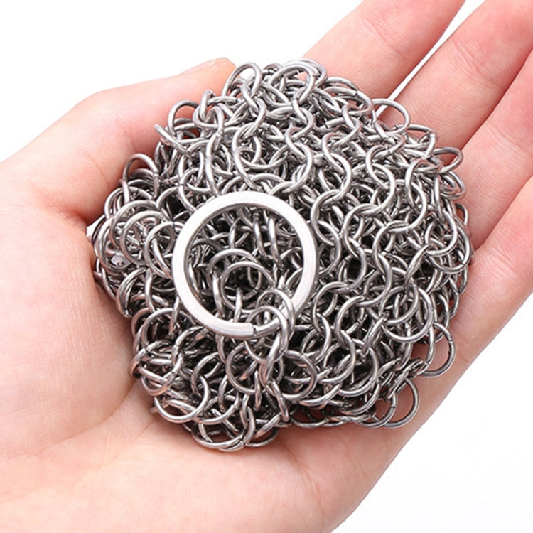 Close-up of stainless steel scrubber net ball texture with circular ring loop