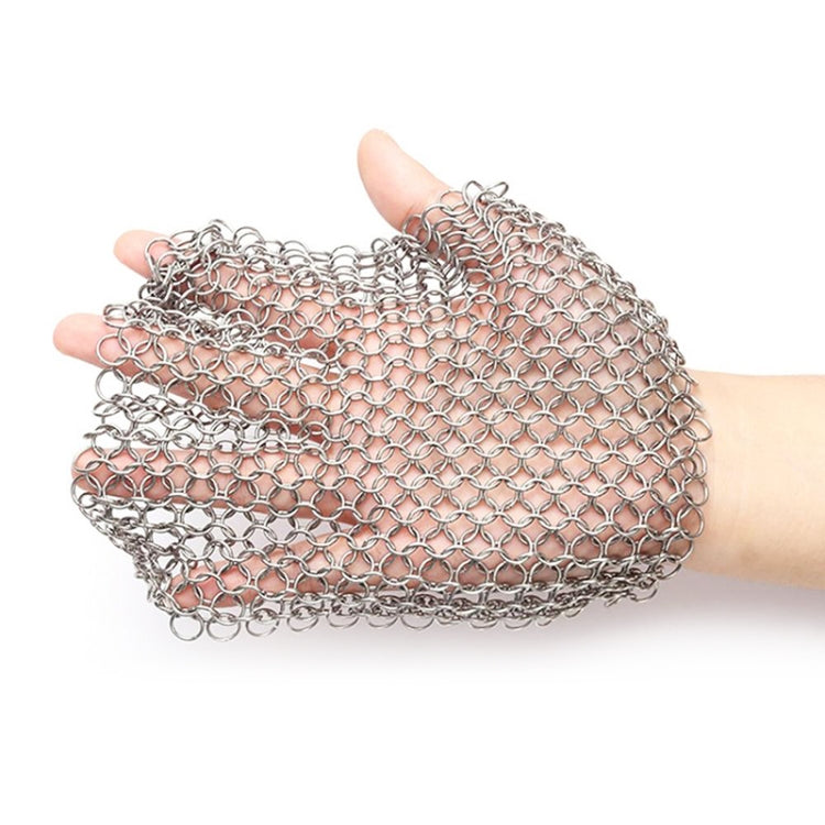 Square stainless steel scrubber net held in hand, metal chain mesh texture