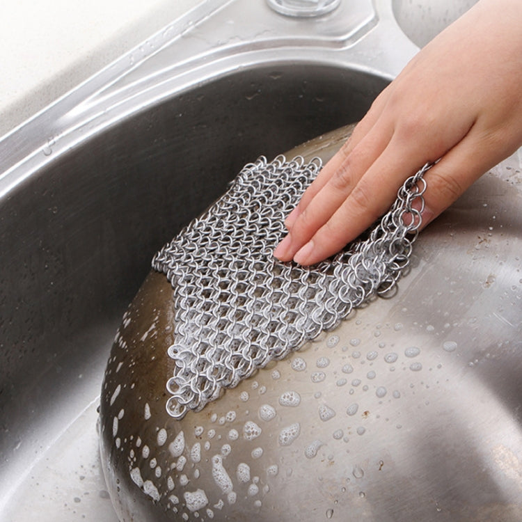 Square stainless steel scrubber net cleaning a stainless sink basin