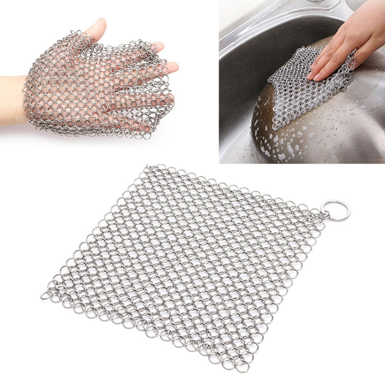 Square stainless steel mesh scrubber pad held in hand, with ring on corner