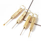 Gold-toned multifunction ear spoon tool set with four slim metal tips and rings