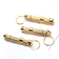 Three gold ear spoon tools with rounded loops and pointed applicator tips