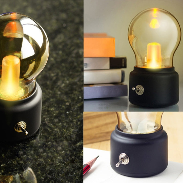 Black USB night light with glowing bulb and metal side knob, shown on tabletop