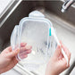Cup brush and tail scraper shown in a clear cleaning container for rinsing