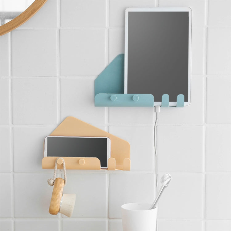 Wall-mounted phone holder with hook arms holding a phone on a tiled wall