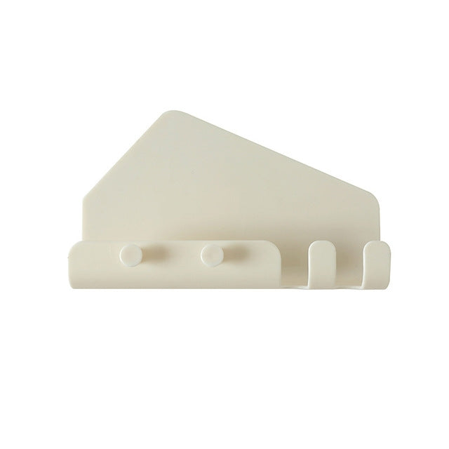 Wall-mounted phone holder with hooks, white back with two circular grips and prongs
