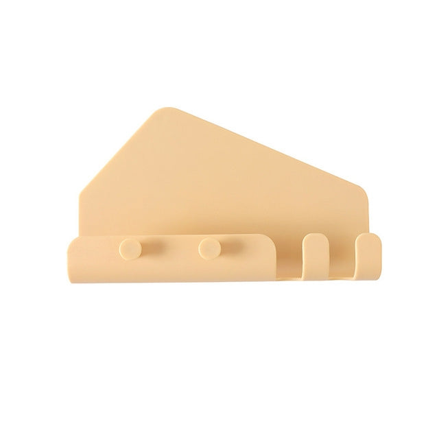 Wall-mounted phone holder with hooks, tan back with two circular grips and prongs