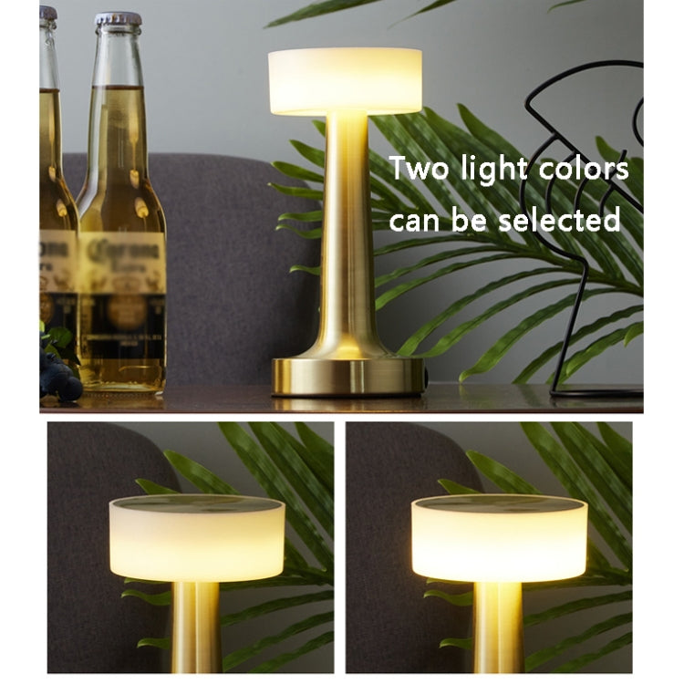 LED table lamp with gold brass base and rounded frosted shade