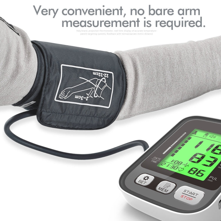 Upper arm blood pressure monitor and cuff fitted on an arm, LCD readout