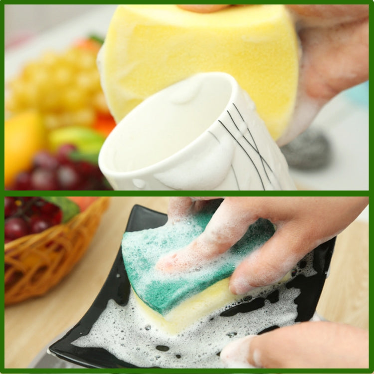 Hand scrubbing with a green-and-yellow scouring sponge eraser on a baking dish