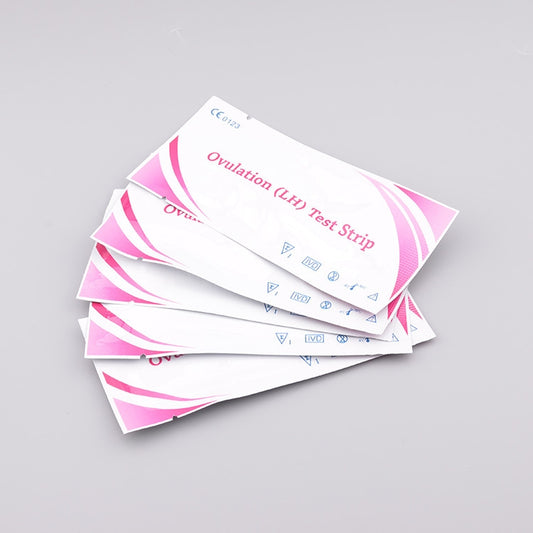 Stack of ovulation (LH) test strip sachets with pink and white wave pattern