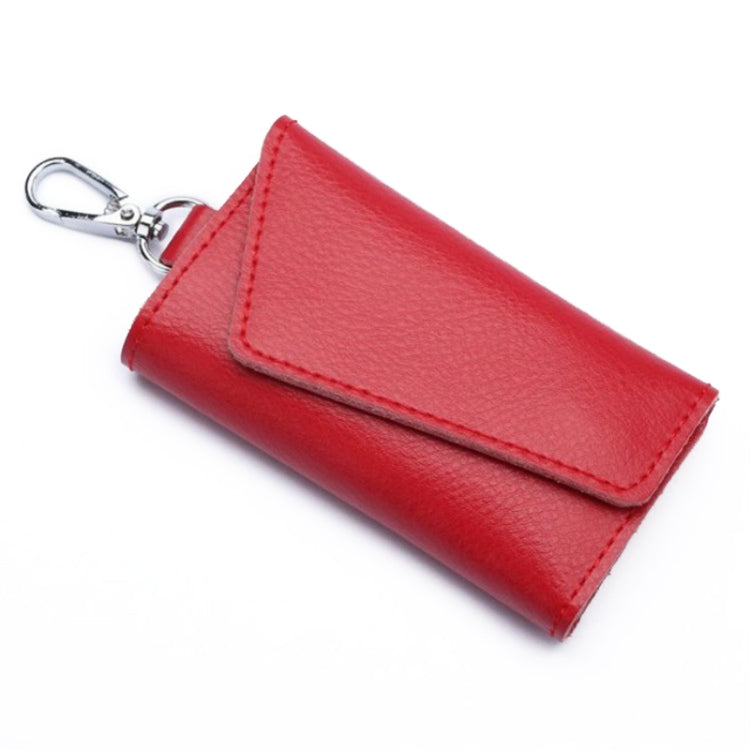 Red leather keychain pouch with stitched snap flap and metal keyring, litchi texture.