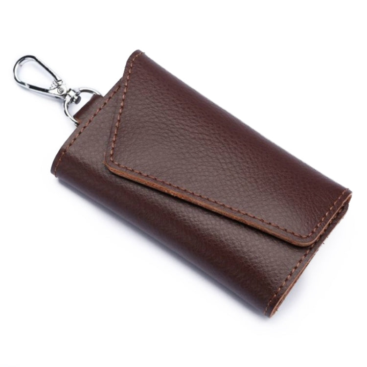 Brown leather keychain pouch with stitched snap flap and metal keyring, litchi texture.