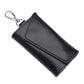 Black leather keychain pouch with stitched snap flap and metal keyring, litchi texture.