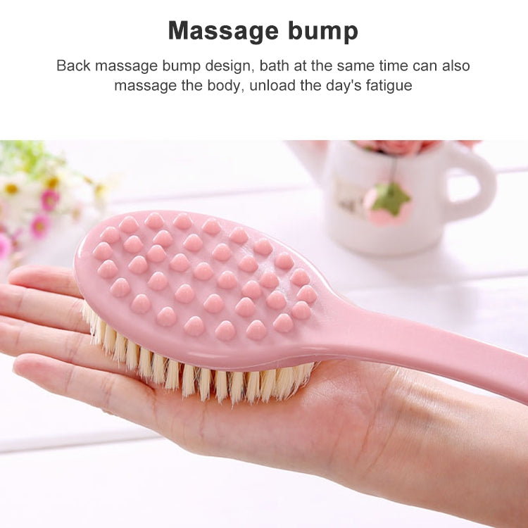 Pink bath brush with oval soft bristle head and raised massage bump backing.