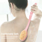 Long-handled bath brush with pink handle and soft bristle head for body cleaning.