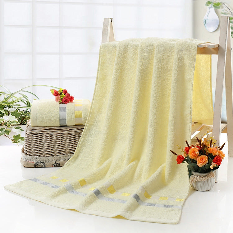 Cotton bath towel in off-white with checkered stripe border and plush loop pile