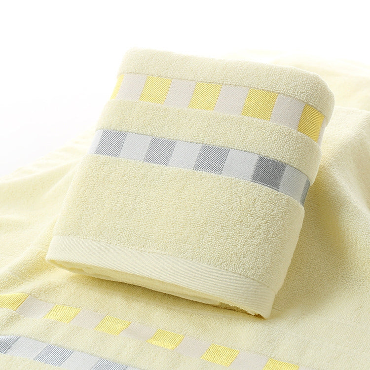 Cotton bath towel roll with off-white terry texture and yellow check stripe border