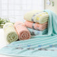Cotton bath towel set in light blue with gray stripe border and rolled towels