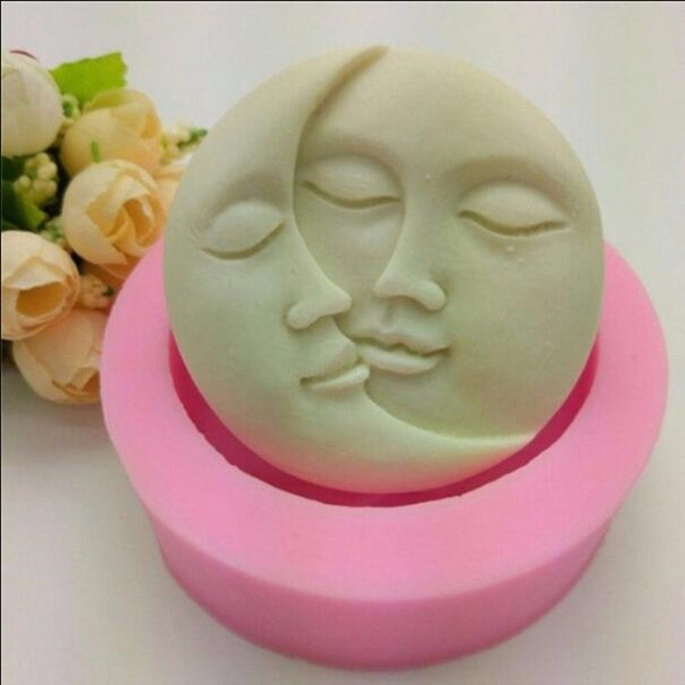 Round silicone face mold: pale mint face relief in pink base.