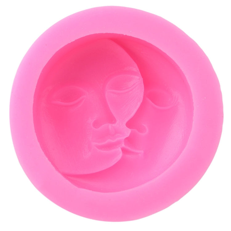 Pink silicone face mold with embossed baby-face relief, circular cavity.