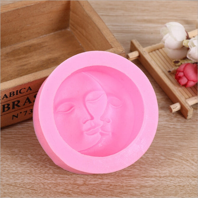 Pink silicone face mold with embossed face relief in circular cavity.
