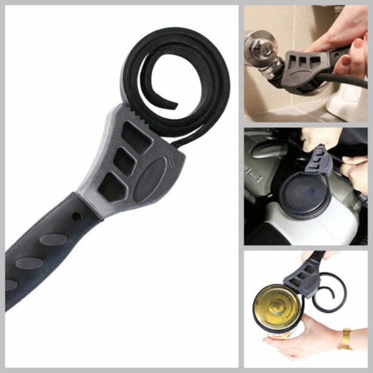 Adjustable belt wrench tool showing curved strap loop and molded jaw, dark gray