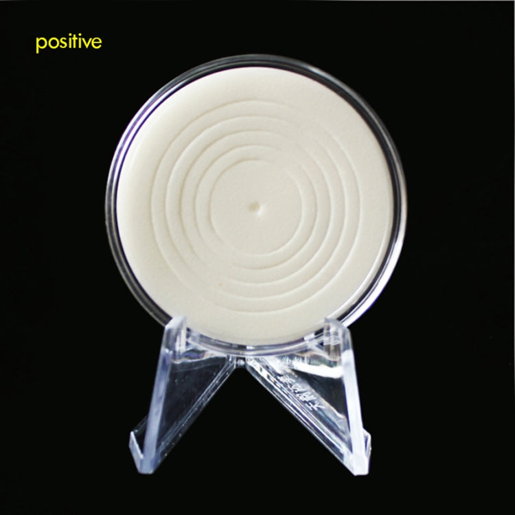 Clear acrylic round coin holder on a three-prong tripod stand