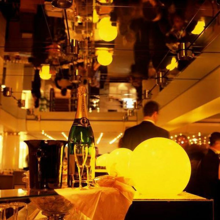 LED globe lights with warm yellow glow on a bar-style setting
