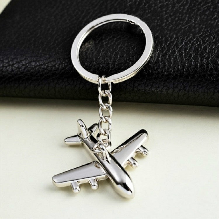 Silver airplane keychain pendant with split-ring and chain on black strap