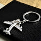 Silver airplane keychain with split-ring and attached chain, viewed from above
