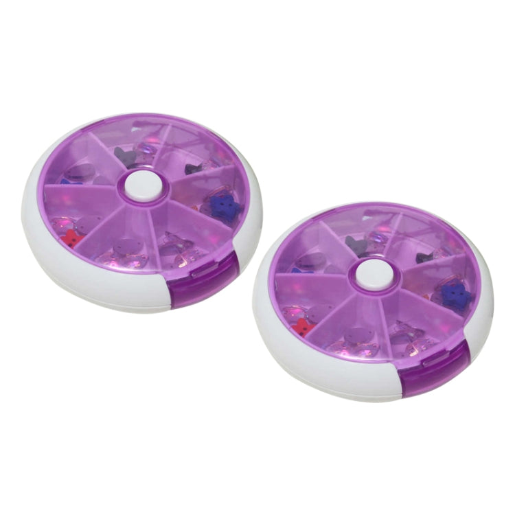 Two purple rotating plastic pill boxes with seven grid compartments, lids open