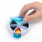 Blue rotating plastic pill box opened to reveal mixed tablets and capsule compartments