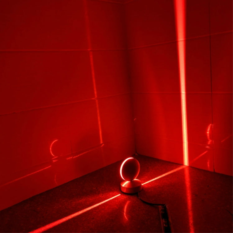 LED wall spotlight with semicircle head emitting red light in room corner